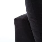 Close-up on armrest seam and cushion fabric of deep charcoal twill sofa