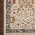 Close-up of Giada rug showing aged-border detail and fringe on dark wood floor