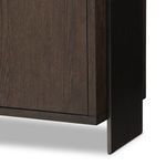 Close-up of black iron side panel and rubbed black oak wood grain on sideboard corner