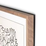 Sharp walnut frame corner with visible wood grain and white wall mount