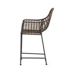 Side close-up emphasizing woven wicker texture and armrest curvature