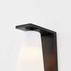 Andros Wall Sconce close-up showing light glowing softly through opal matte glass shade