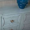 Angled close-up of top corner and ring pull of the Sara Cabinet with wood grain and blue-grey finish