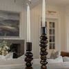 Pair of Foundation Candleholders with unlit white taper candles on wooden surface in rustic room