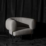 Reina Accent Chair staged in a black fabric studio setting with soft shadows and soft gray upholstery