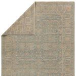 Partial view of rug back with folded corner revealing intricate Persian knot construction and tonal colors
