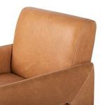 Rear angled view showing smooth leather back and broad padded arms extending down sides