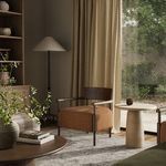 Bennett Chair placed in natural light highlighting ochre fabric against beige curtain background