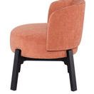Side angle highlighting chair's curved backrest and thick seat cushion in nectarine fabric