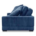Side profile of Plunge Sofa highlighting channel texture and cushion layering in blue