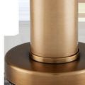 Close-up of the brushed brass base and cylindrical stem of La Gravite Mini Table Lamp