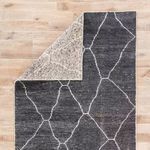 Back side of Satellite Rug flipped corner showing lighter neutral gray with reversed geometric pattern