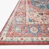 Angled close-up of the rug’s textured weave showing the coral border and intricate motifs