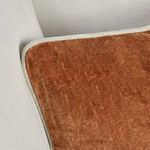 close-up of pillow piping and velvet fabric against light gray sofa fabric