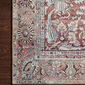 Detailed view of rug border with floral motifs resting on dark hardwood floor