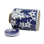 Mini jar positioned on side with plum blossom design and lid beside it