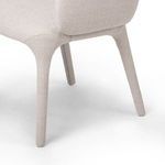 Detail view of upholstered armchair’s rear leg and seat joint