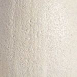 Extreme close-up of the vase’s textured surface featuring small pits and creamy glaze