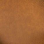 Close-up of smooth cognac top grain leather texture on chair surface
