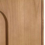 Close-up showing fine vertical grain texture and smooth finish on oval door handle