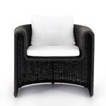 Front view of wicker chair focusing on waterfall arms and wide cushioned seat