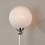 Close-up of frosted white glass globe light illuminated with visible light texture