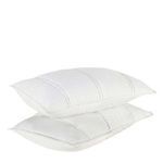 Two cloud white shams stacked, angled to show thickness and plush quilting