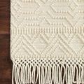 Detailed corner view on hardwood floor highlighting raised geometric texture and fringe tassels