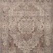 Traditional power-loomed rug with a central medallion and intricate floral motifs in muted berry and stone tones