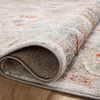 Rolled corner revealing plush pile and underside weave of the rug