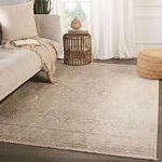 Living room scene with the rug under a sofa and natural-toned accessories near white curtains