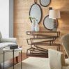 Living room wall featuring three mirrors in different shapes and sizes on wood plank wall