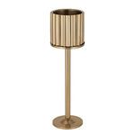 Side view of the gold steel ice bucket stand with the ribbed cylindrical bucket on the tray