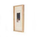 Side profile view of natural oak frame showing depth and layering of collage inside
