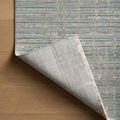 Wade Spa Sand Rug corner lifted to reveal backing and power-loomed polyester weave