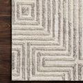 Close-up of Ehren rug corner placed on dark hardwood flooring highlighting pattern detail and texture