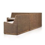 Back and side angled view of banquette highlighting rattan texture and cushion contrast