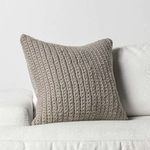 Pillow styled upright on white sofa to showcase size and color contrast in living space