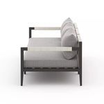 Side view showing rope-wrapped armrests and thick gray seat cushion of Sherwood outdoor sofa