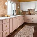 Giada Blush rug shown as a runner in a kitchen with dark wood flooring and blush cabinetry