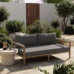 Sherwood sofa placed on outdoor patio among shrubs with side table and accessories
