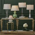 Group of four lamps on gold and glass console table, Deville Table Lamp positioned second from right