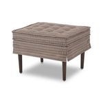 Three-quarter angle of Cole Ottoman displaying tufted top and fabric details
