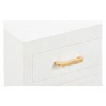 Close-up of one gold leaf handle and the textured white raffia drawer surface
