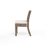 Side profile of Havana chair showing curved wicker backrest and cushioned seat