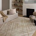 living room scene with rug under sofa and chair enhancing neutral decor and modern design