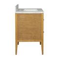 Partial front and left side view emphasizing carved rattan drawer fronts and solid mahogany frame
