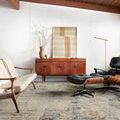 Axel Rug shown in a modern living room setting with midcentury furniture and white walls