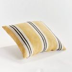 Theo pillow shown at a three-quarter angle highlighting its plump shape and striped pattern