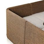 Interior view focusing on rattan weave along the base and side panels of the banquette